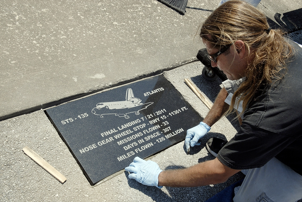The plaque marking the final nose gear wheel stop of space shuttle Atlantis.