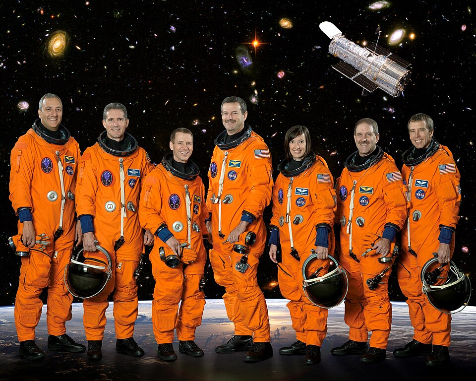 From the left are astronauts Michael J. Massimino, Michael T. Good, both mission specialists; Gregory C. Johnson, pilot; Scott D. Altman, commander; K. Megan McArthur, John M. Grunsfeld and Andrew J. Feustel, all mission specialists. The STS-125 mission will be the final space shuttle mission to the Hubble Space Telescope.